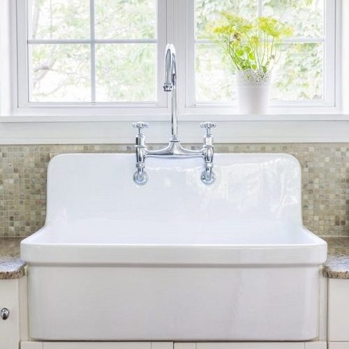 A Picture of a Kitchen Interior with a Large Rustic White Porcelain Sink.