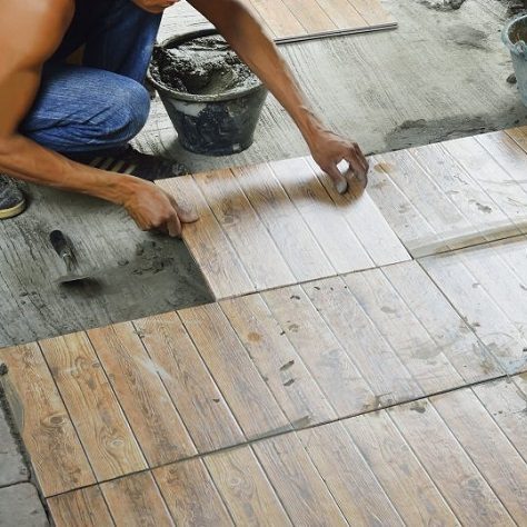 A Picture of a Man Installing Tiles.