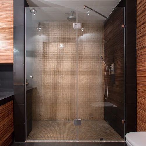 A Picture of a Luxury Shower That Has Wooden Details.